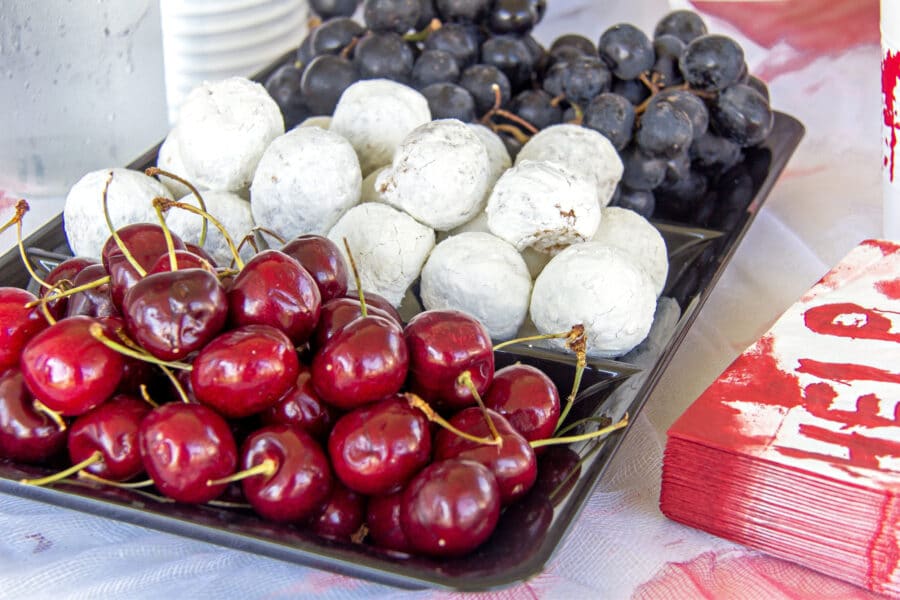 cherries, powdered donuts, and black grapes for a red black and white themed halloween party